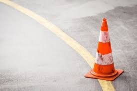 A yellow stripe on the street indicating a buffer zone.