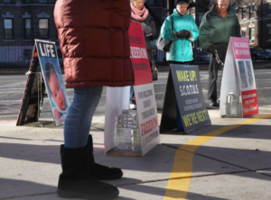 Anti-abortion protesters lined up outside a buffer zone.